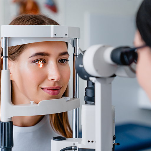 A woman having an eye examination at a slit lamp