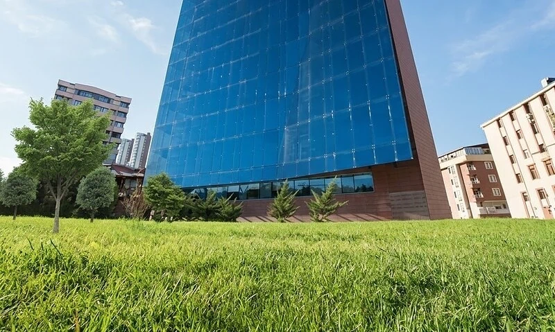 Modern glass facade of Acibadem Ankara Hospital skyscraper.