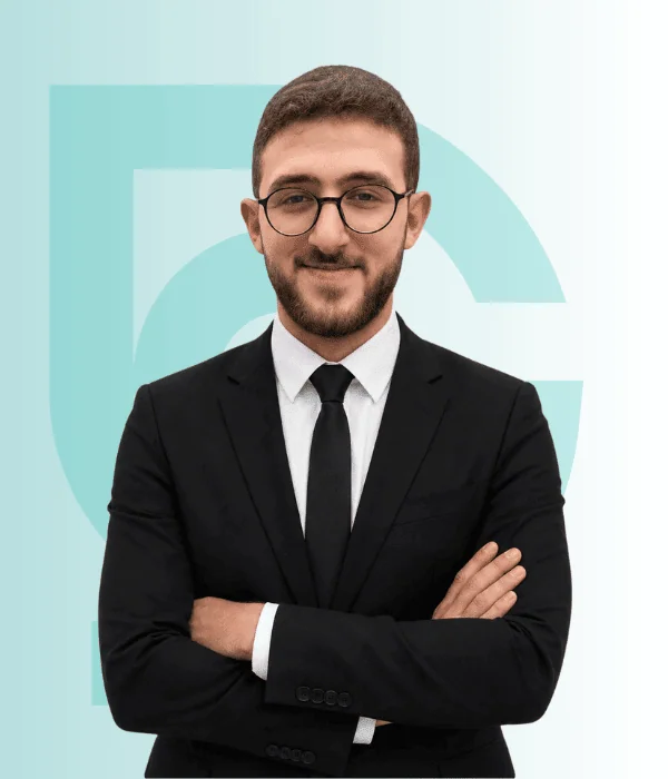 Dr. Tarek Arafat 1 Young man in formal suit with glasses smiling confidently.