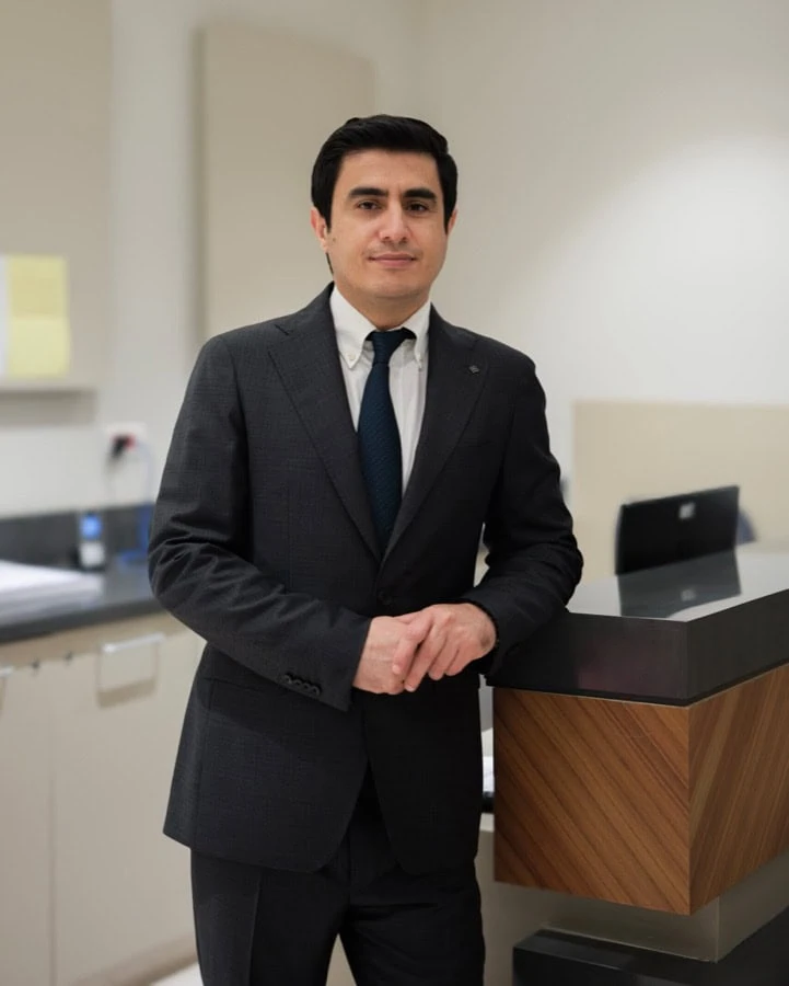 Assoc. Prof. Dr. Mustafa Çorum, physical medicine and rehabilitation specialist, standing in a consulting room